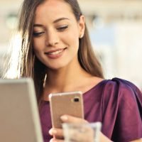 women working and watching phone